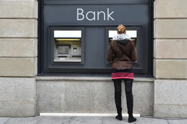 Девушка в банкомате — стоковое фото